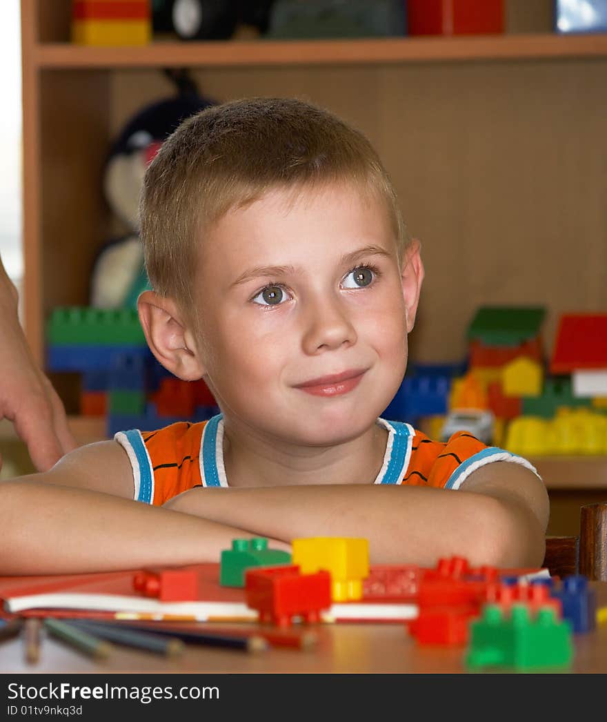 The boy of 7 years is engaged in a children's room