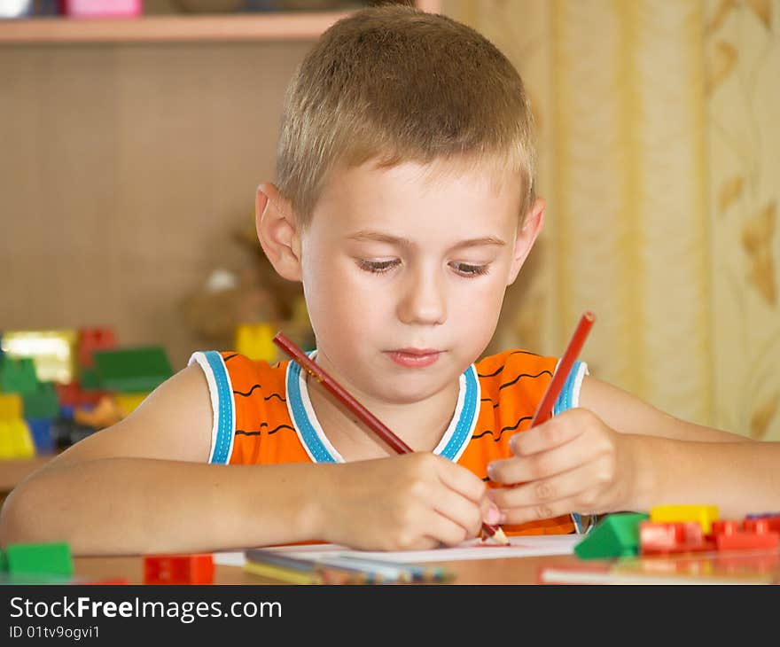 The boy of 7 years is engaged in a children's room. The boy of 7 years is engaged in a children's room