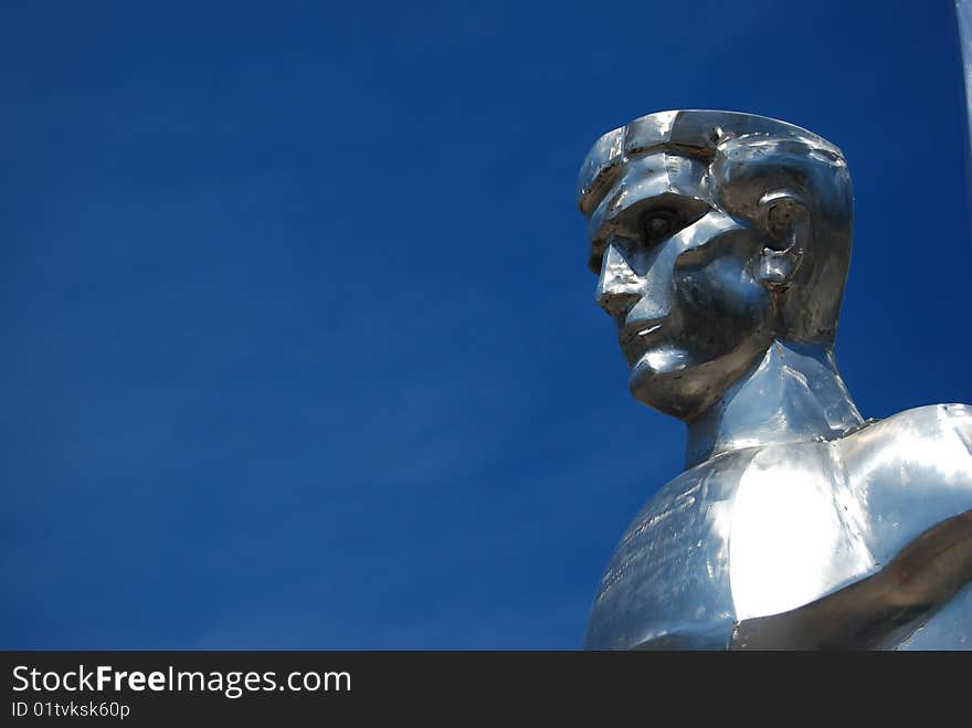 Metal sculpture of a hero with a blue sky on background. Metal sculpture of a hero with a blue sky on background