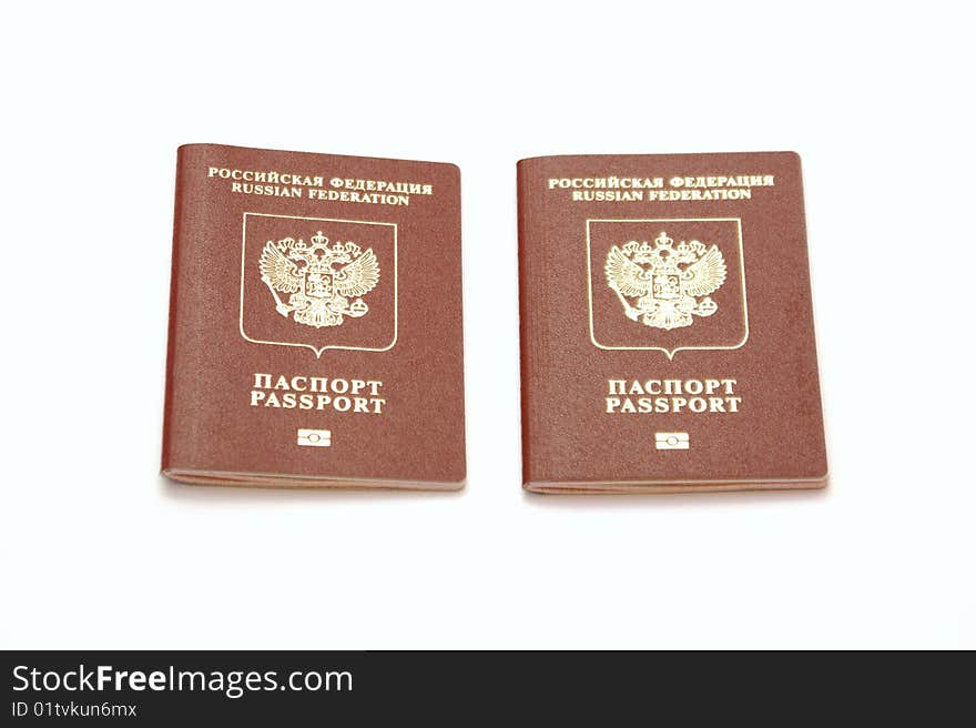 Three passports for travel abroad on a white background are removed by close up