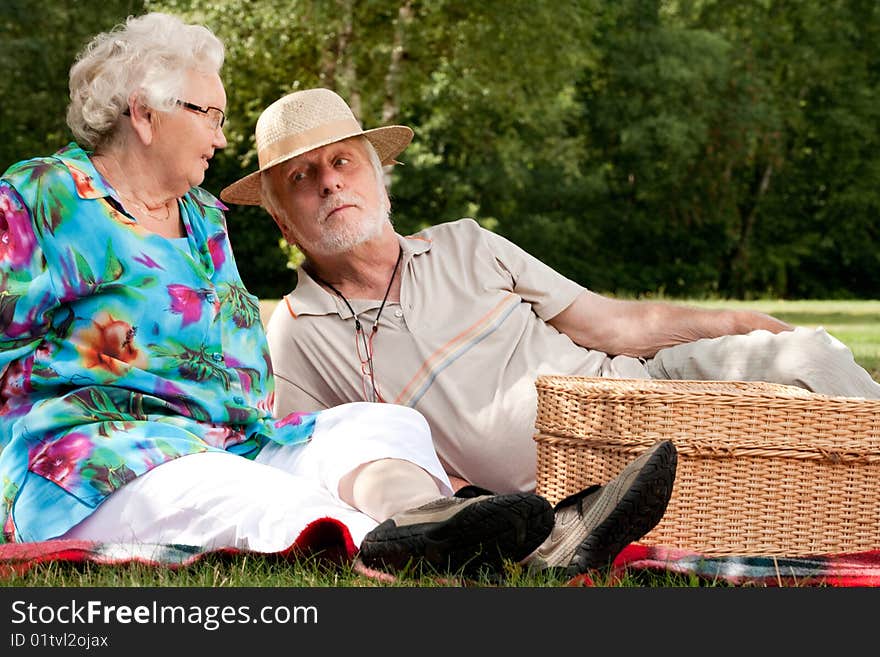 Elderly couple enjoying the spring in the park. Elderly couple enjoying the spring in the park