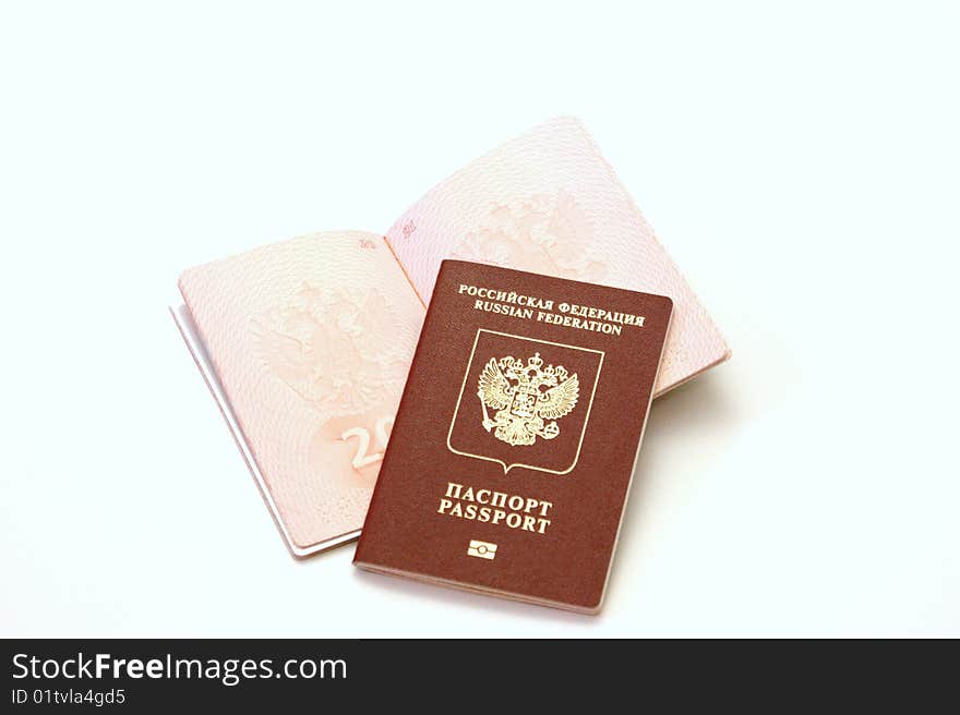 Three passports for travel abroad on a white background are removed by close up