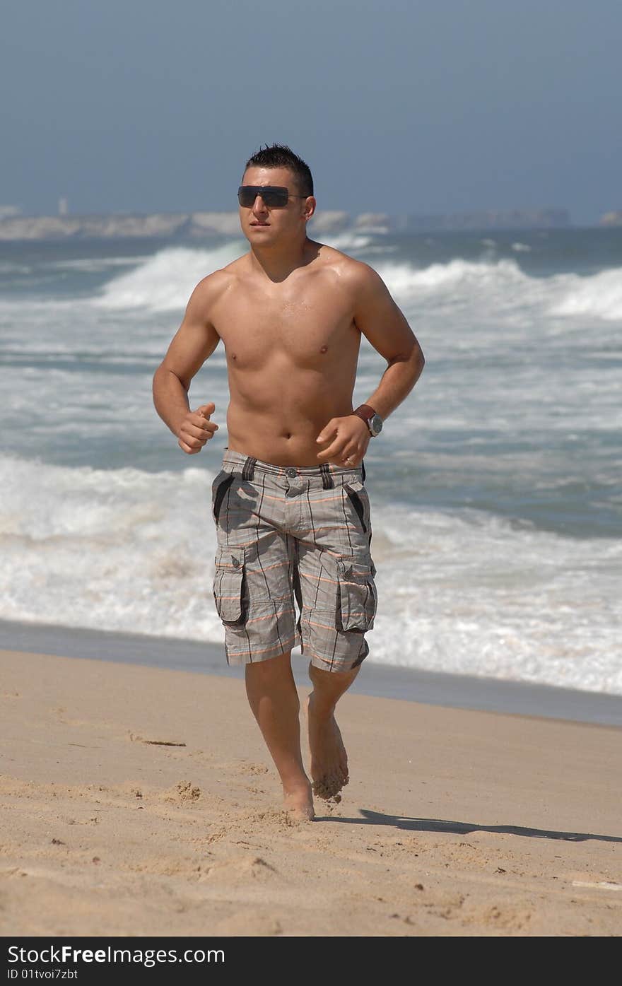 A young men running on the beach