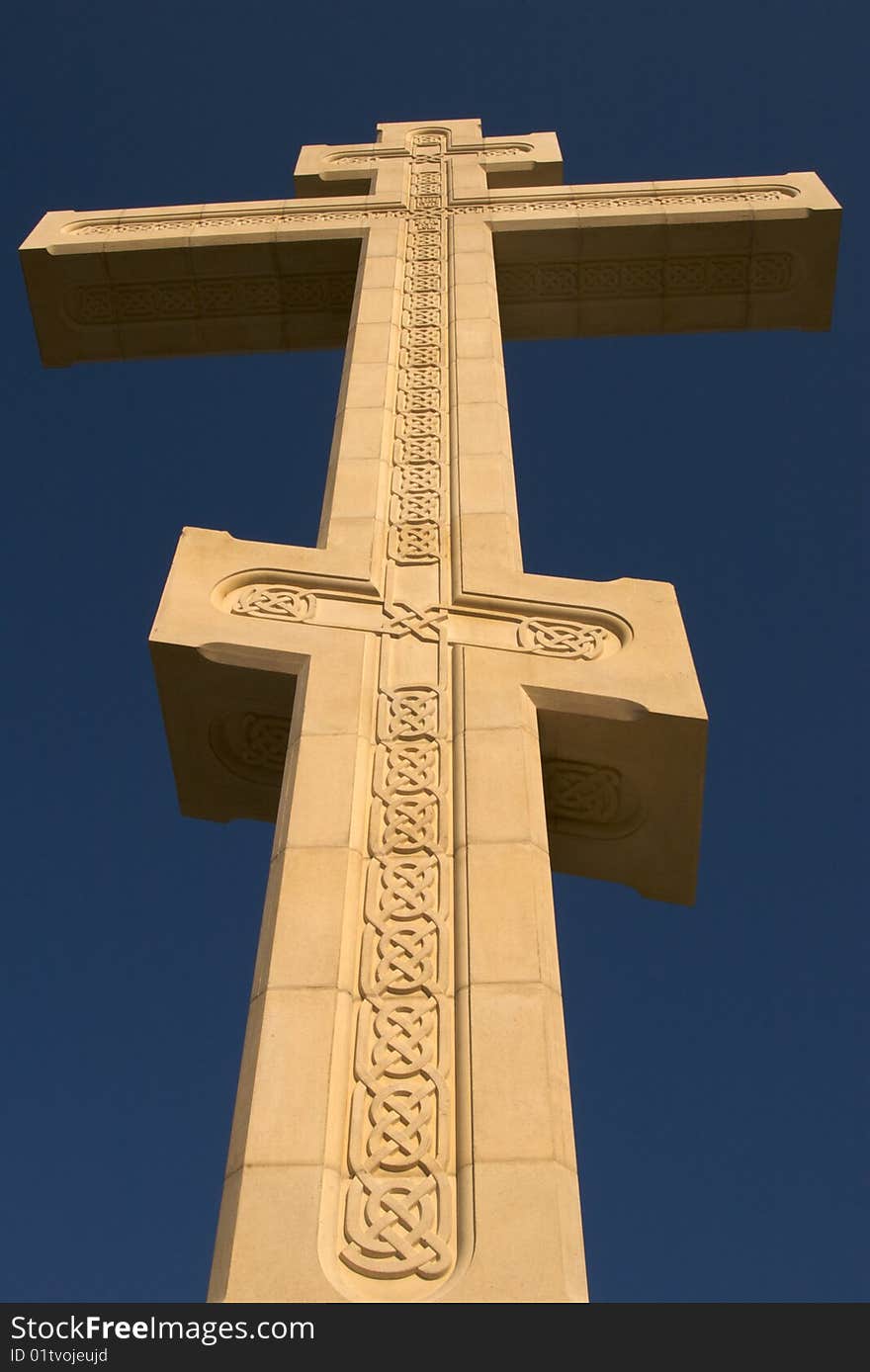 Old cross and sky, yellow limestone, fretwork. Old cross and sky, yellow limestone, fretwork