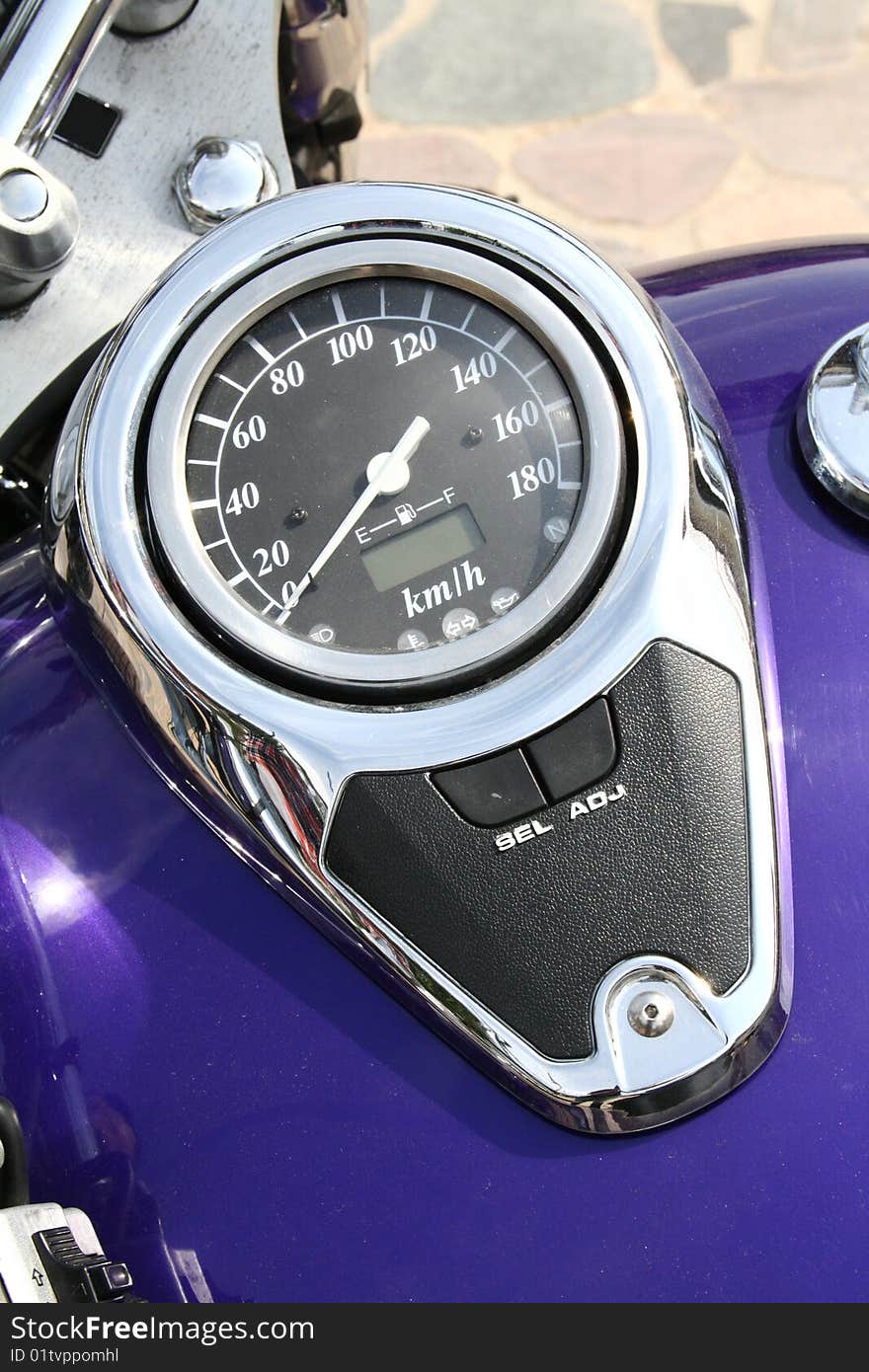 A speedometer of a blue motorcycle in close up. A speedometer of a blue motorcycle in close up