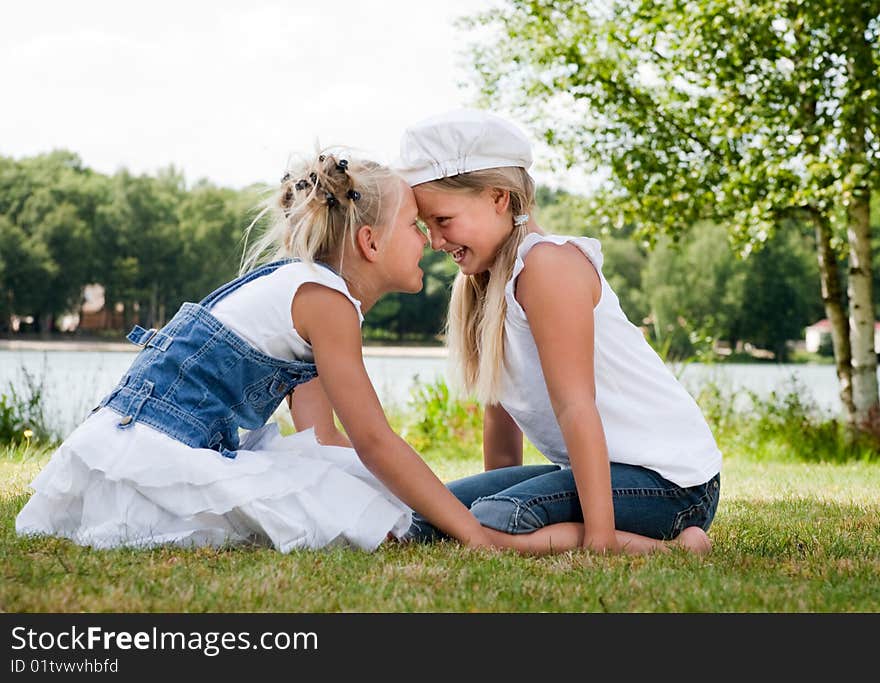 Two little girls in fresh colors in the park. Two little girls in fresh colors in the park