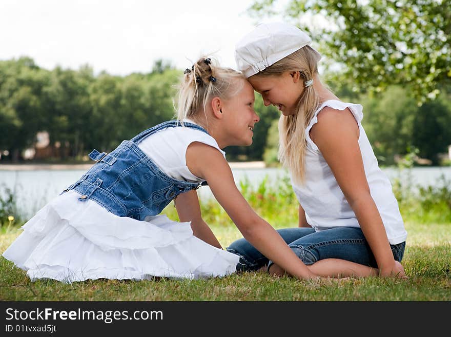 Two little girls in fresh colors in the park. Two little girls in fresh colors in the park