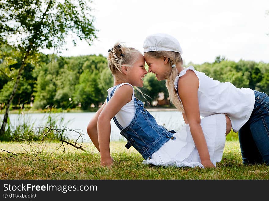 Two little girls in fresh colors in the park. Two little girls in fresh colors in the park