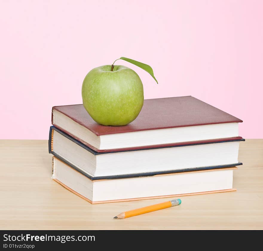 Apple And Pencil On Top Of Books