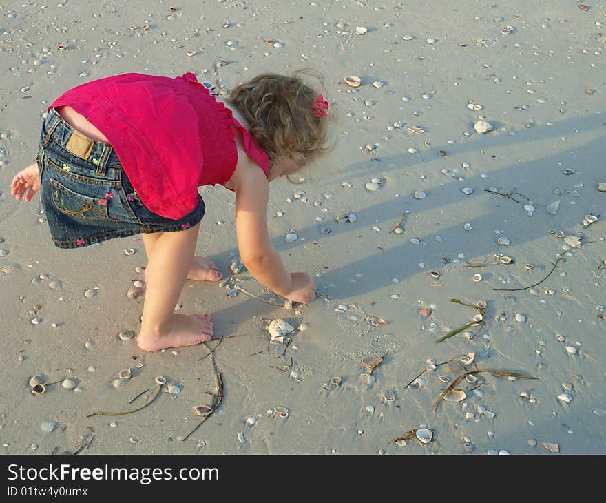 Photo of a little girlalone on the beach. Photo of a little girlalone on the beach