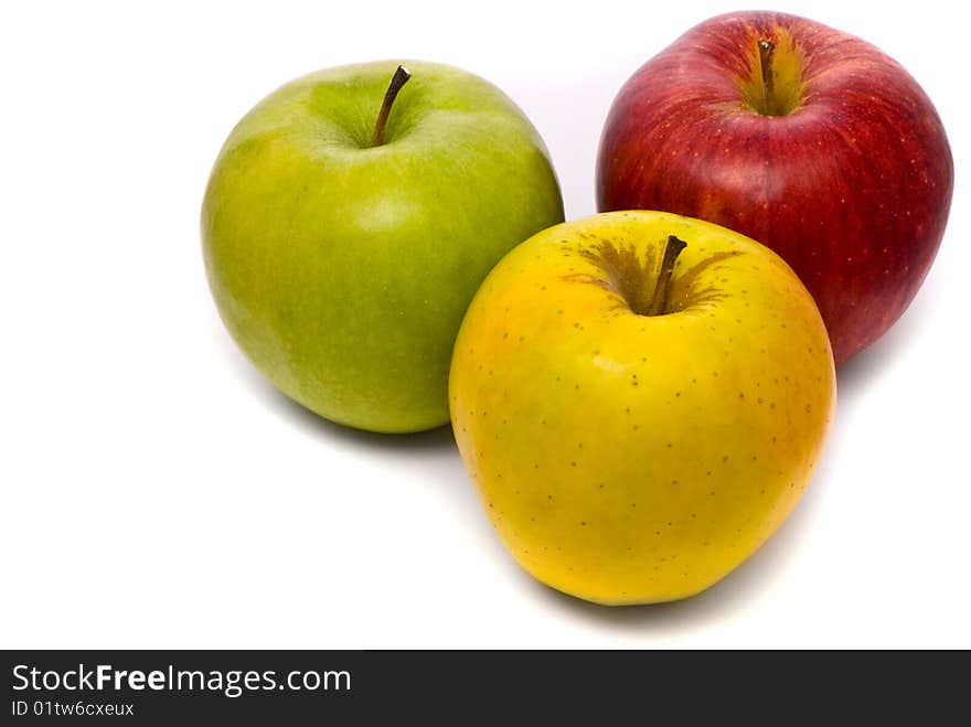 Red, yellow and green fresh apples on studio white