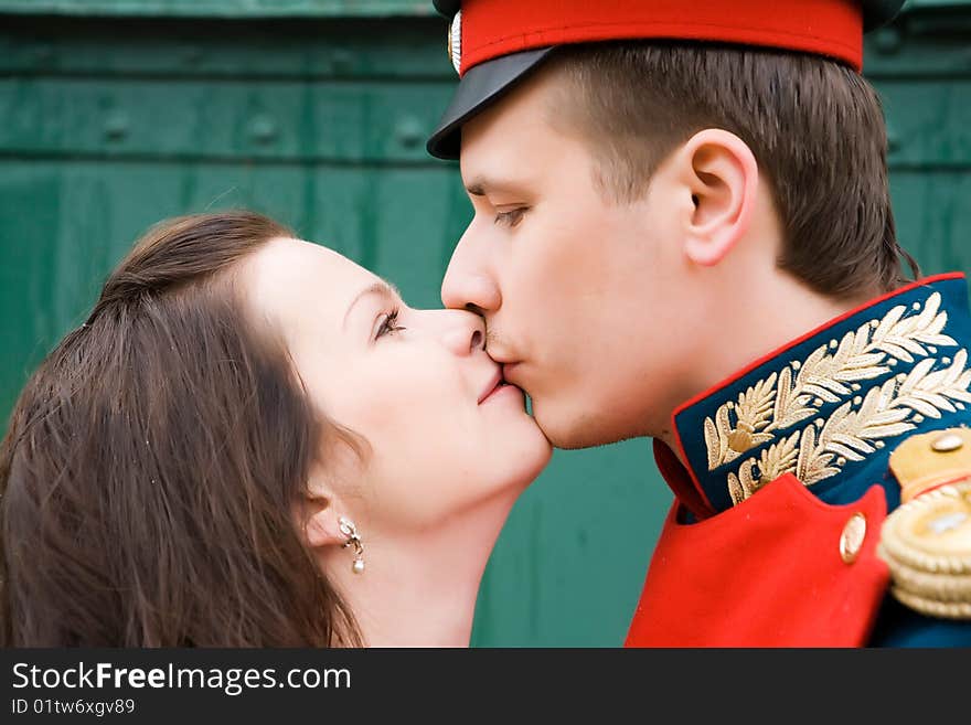 Young couple kissing infront of train