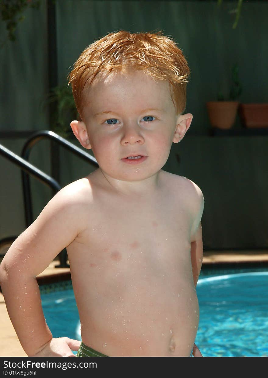 Photo of a redheaded little boy with his hands on his hips. Photo of a redheaded little boy with his hands on his hips