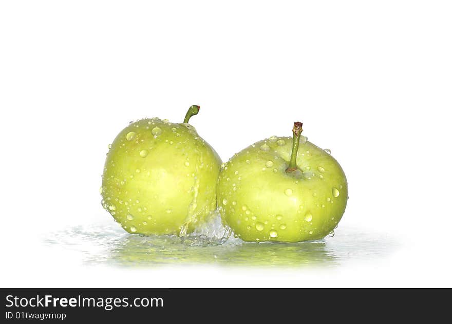 Two fresh green apples under water drops isolated on white background with clipping path