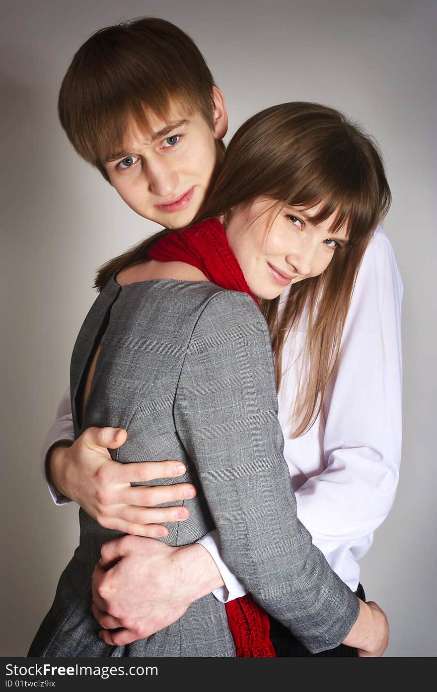 Smiling young couple on gray background. Smiling young couple on gray background