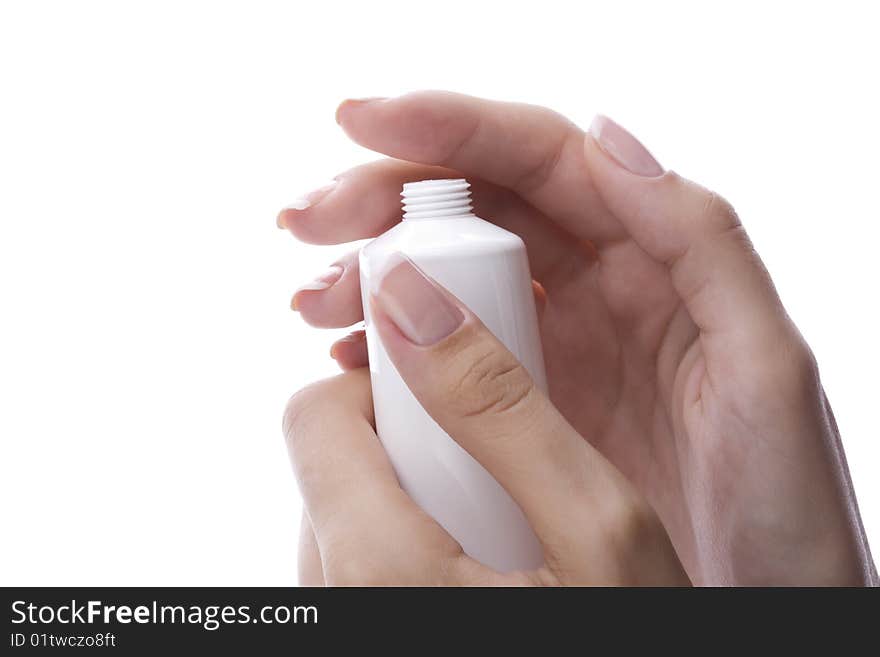 Well-groomed female hand holding a cream tube. Well-groomed female hand holding a cream tube