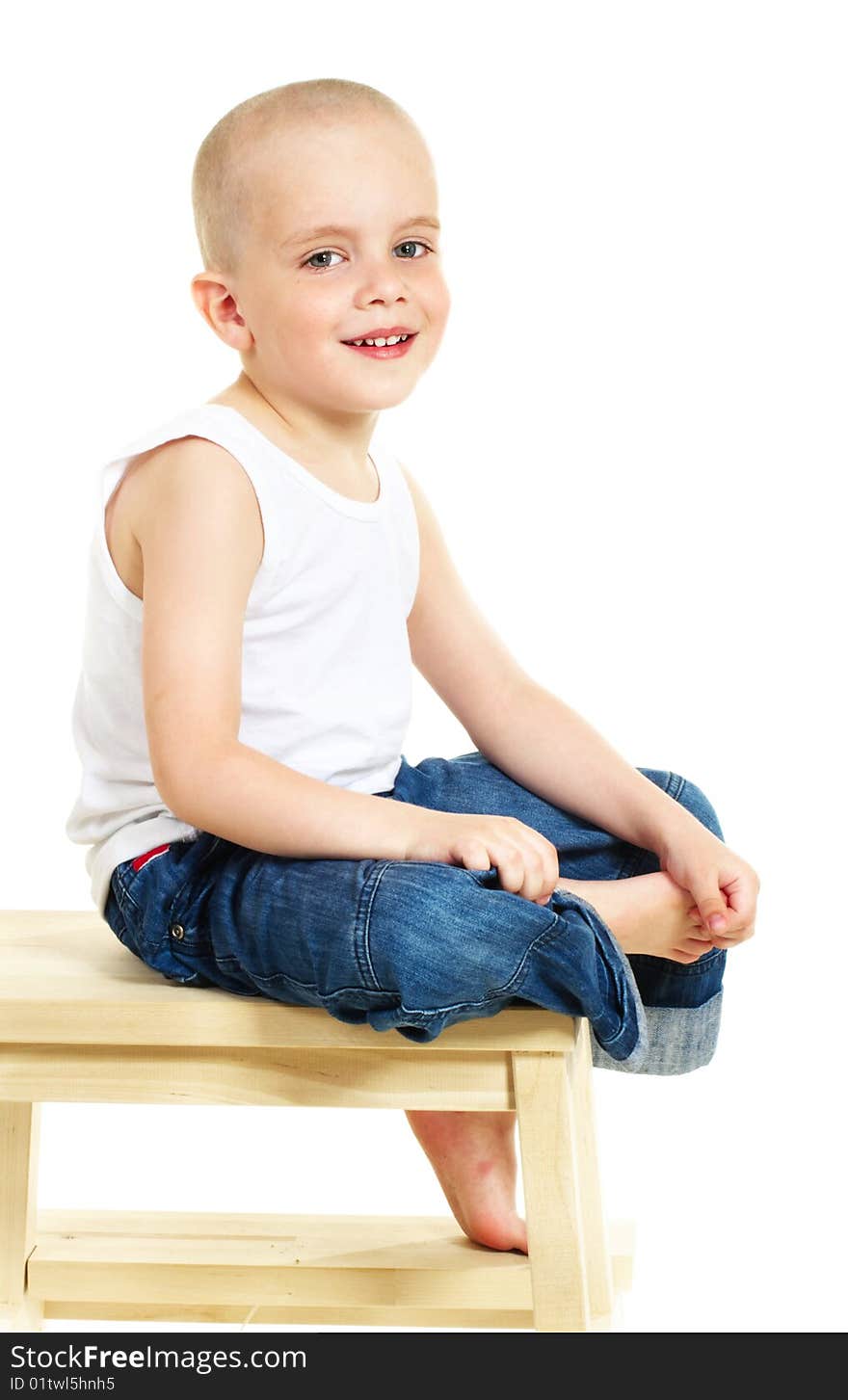 Laughing little boy sitting on stool