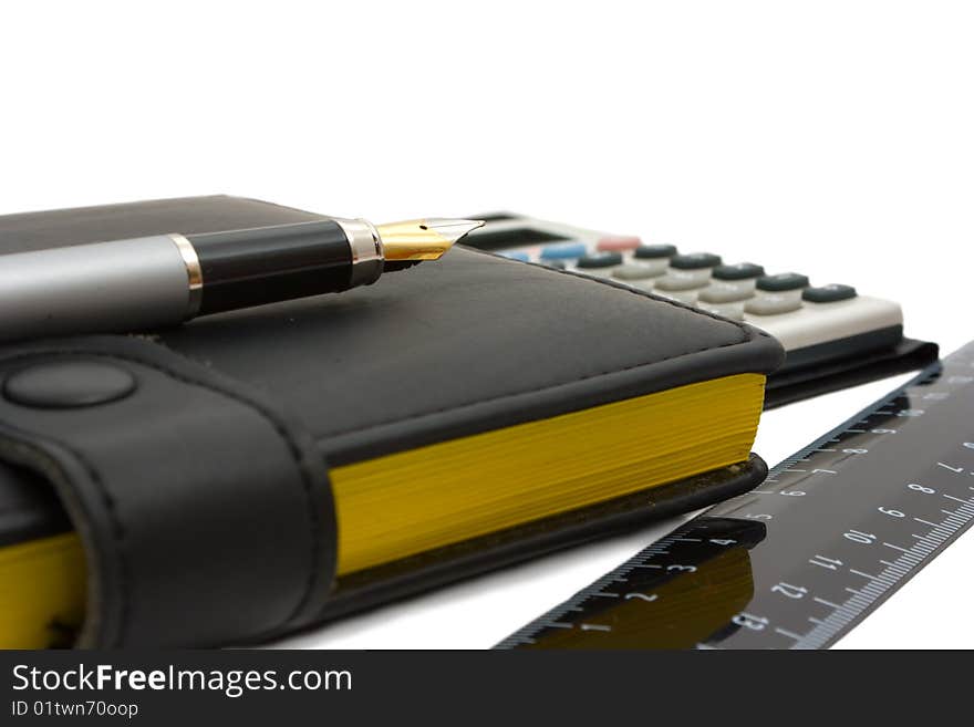 Business still-life: fountain pen, diary, calculator and ruler