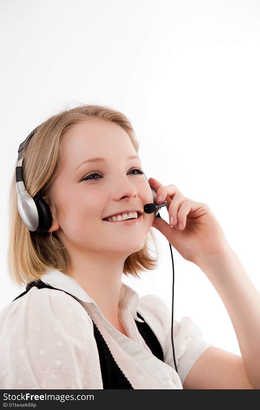 Young woman listens with smile - headset. Young woman listens with smile - headset