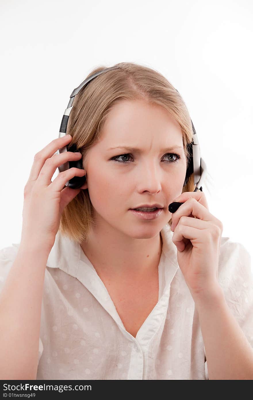 Confused young woman talks on a headset. Confused young woman talks on a headset