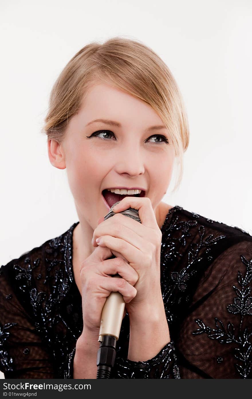 Young fun and bubbly woman sings into microphone with fervour. Young fun and bubbly woman sings into microphone with fervour