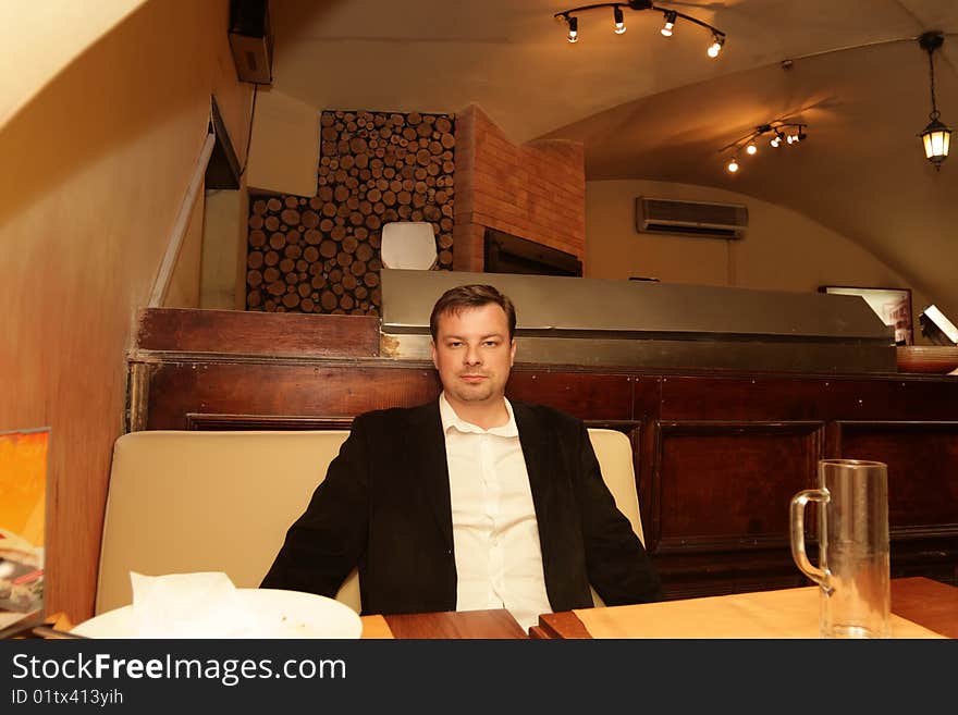 The man poses after dinner in a restaurant. The man poses after dinner in a restaurant