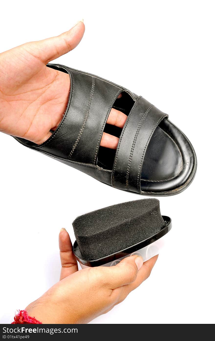 Female hand polishing black footwear. Female hand polishing black footwear.