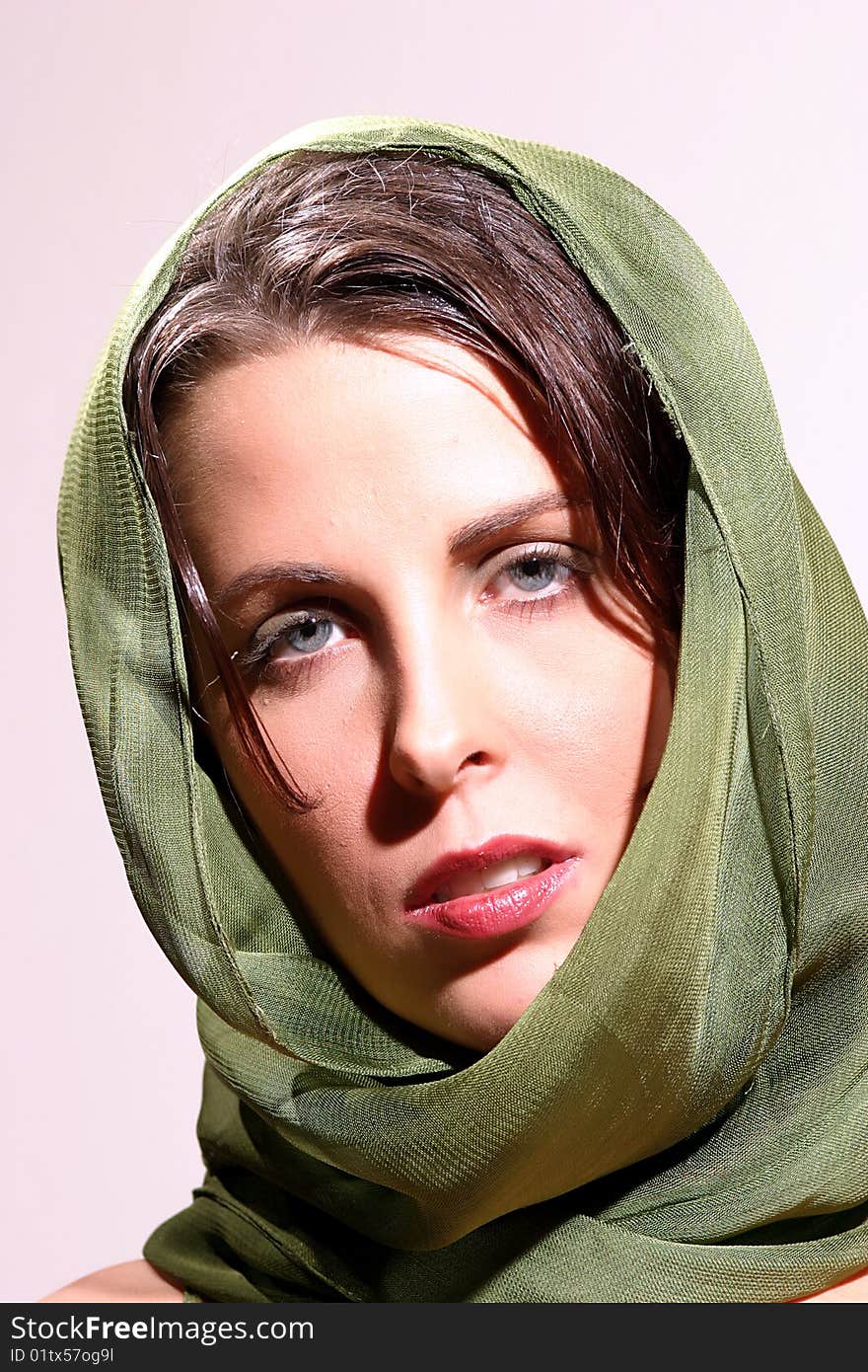 Attractive Brunette Woman poses in a with a green scarf. Attractive Brunette Woman poses in a with a green scarf