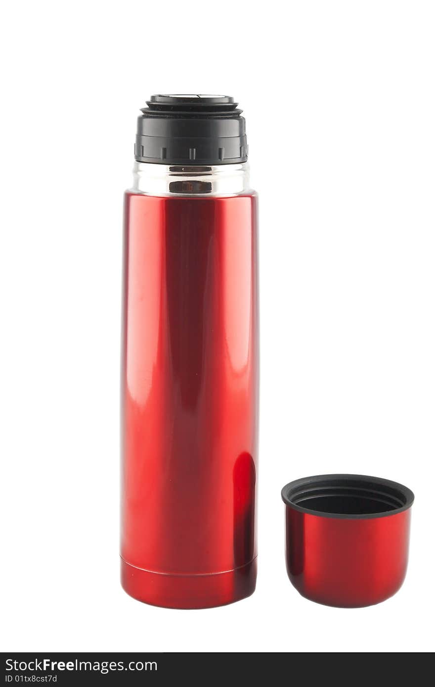 Red metal thermos  with cup nearby