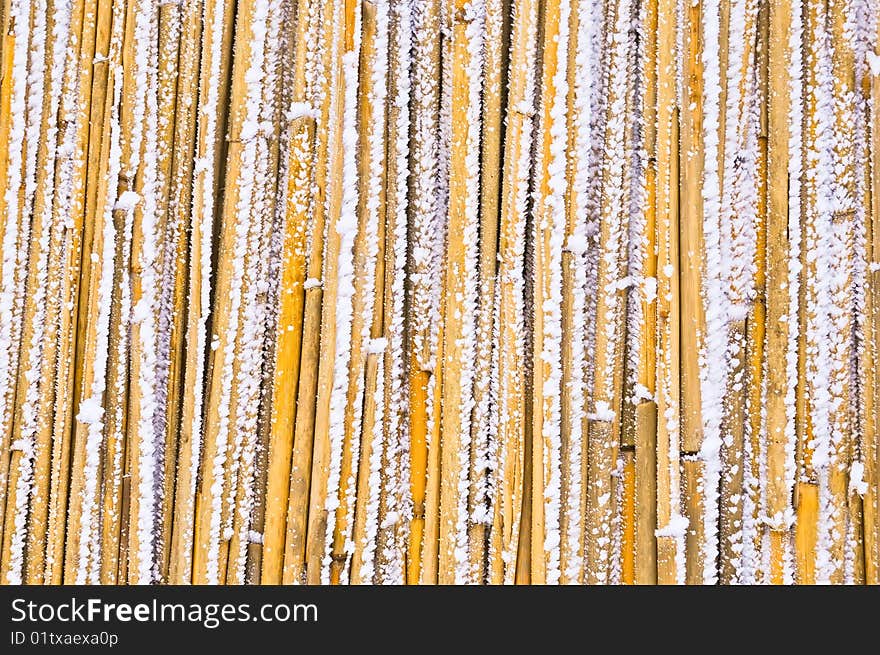 A yellow straw background is covered a hoarfrost. A yellow straw background is covered a hoarfrost