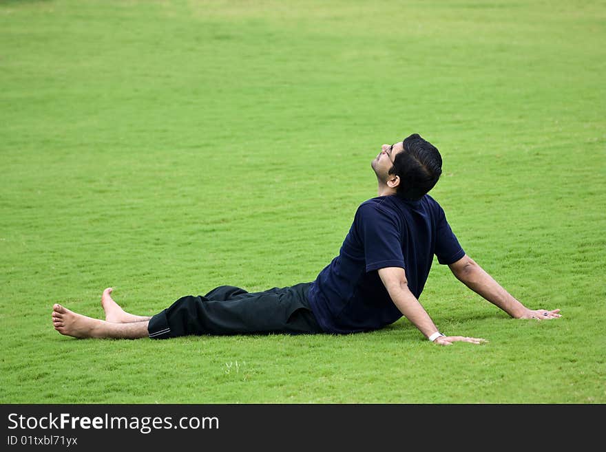 A men taken rest over green grassland. A men taken rest over green grassland