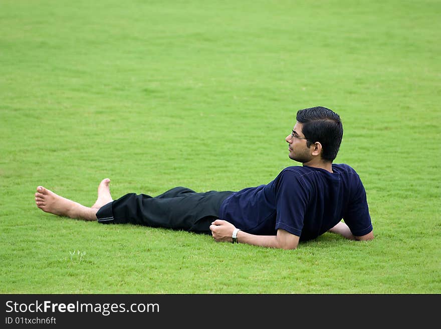 A men taken rest over green grassland. A men taken rest over green grassland