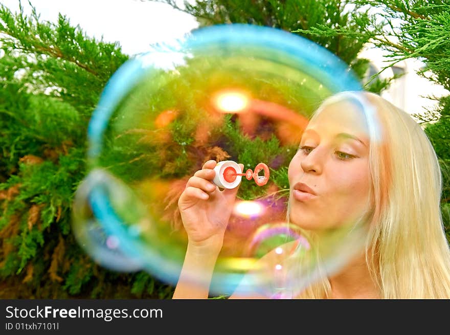 Young smiling woman blow bubbles. Young smiling woman blow bubbles