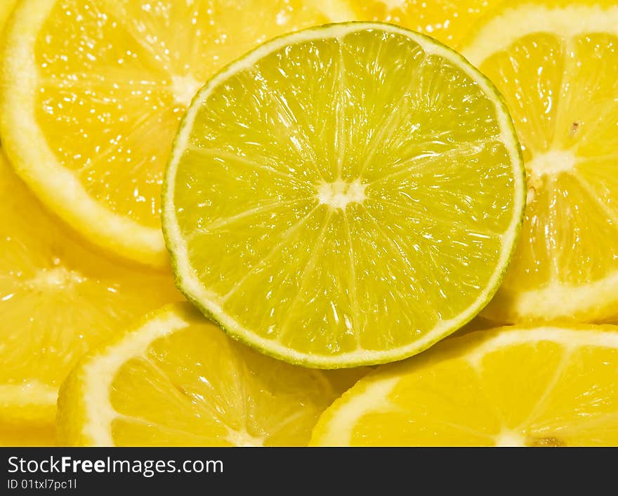 Lime round cut segment between lemons. Lime round cut segment between lemons