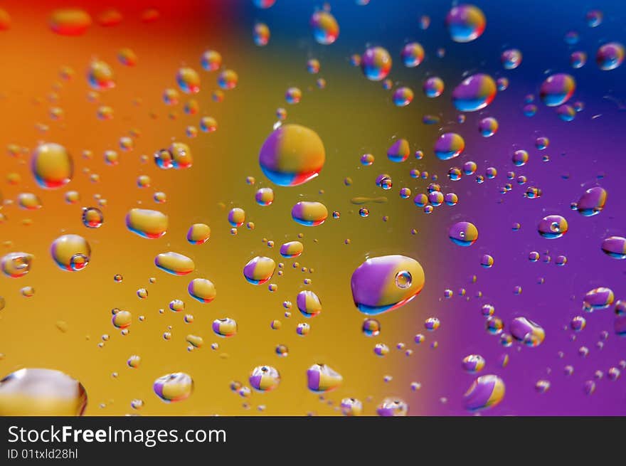 Coloured drops of water on the coloured background