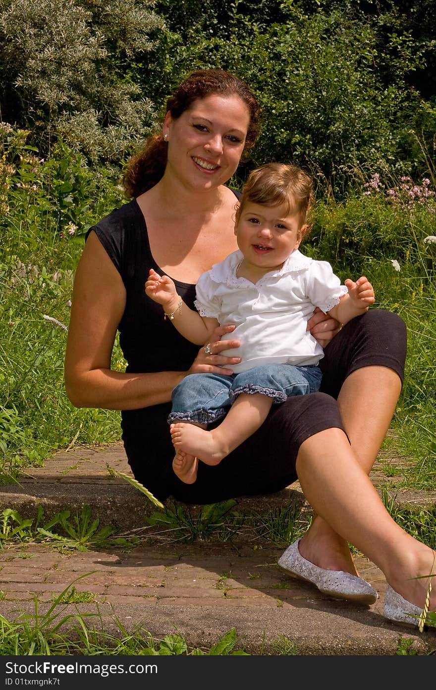 A mother with her daughter on her lap. A mother with her daughter on her lap