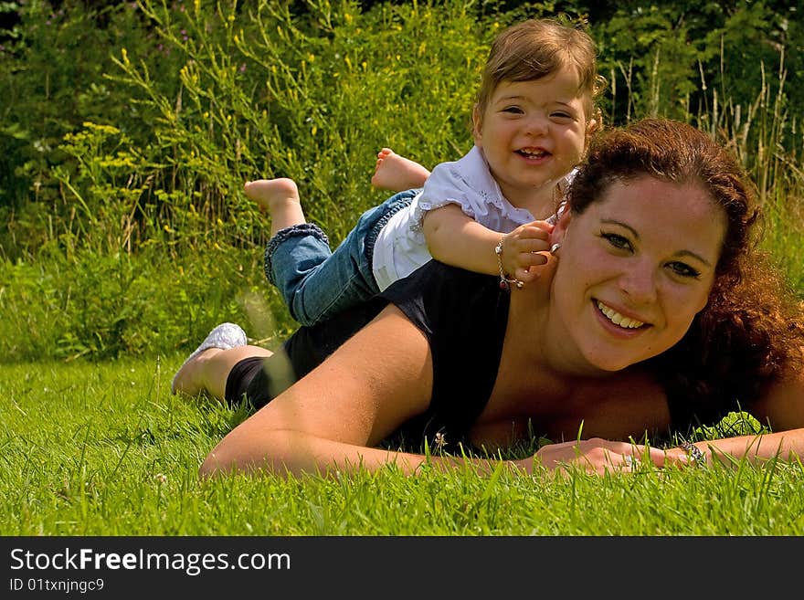 A mother with her daughter lying on her back. A mother with her daughter lying on her back