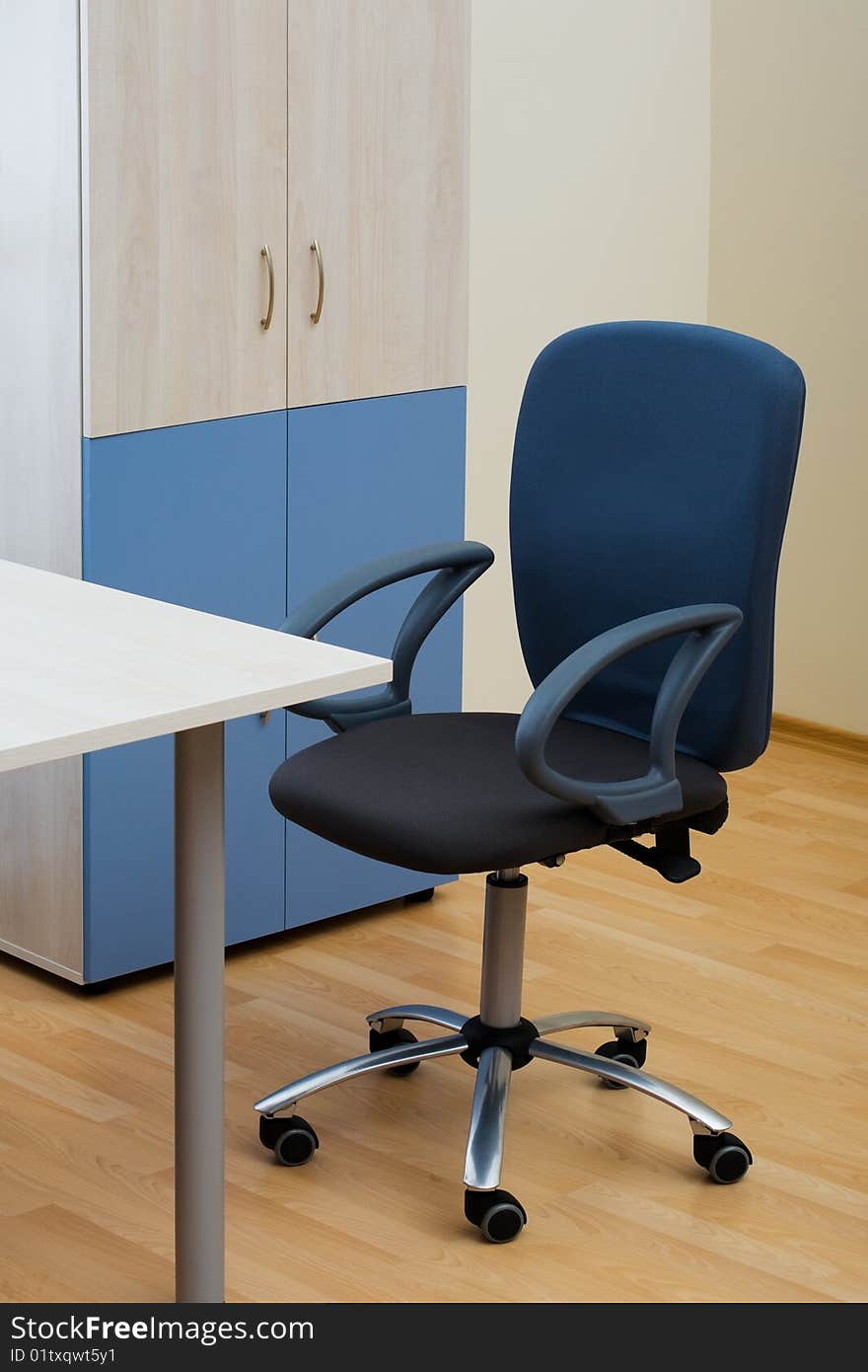 Table, chairs and bookcase at modern office