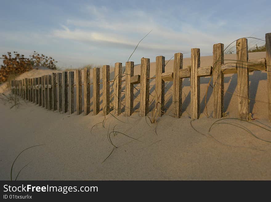 Strips of wood on a beach buried on sand. Strips of wood on a beach buried on sand