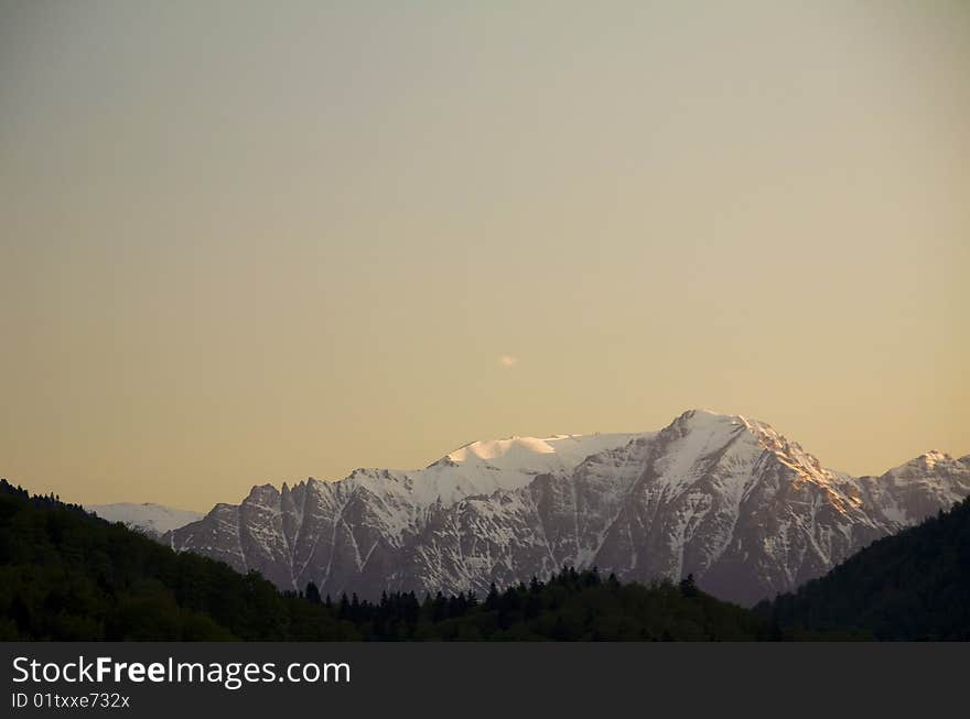 Snow peaks in the sunset, Carpathian mountains, Romania.