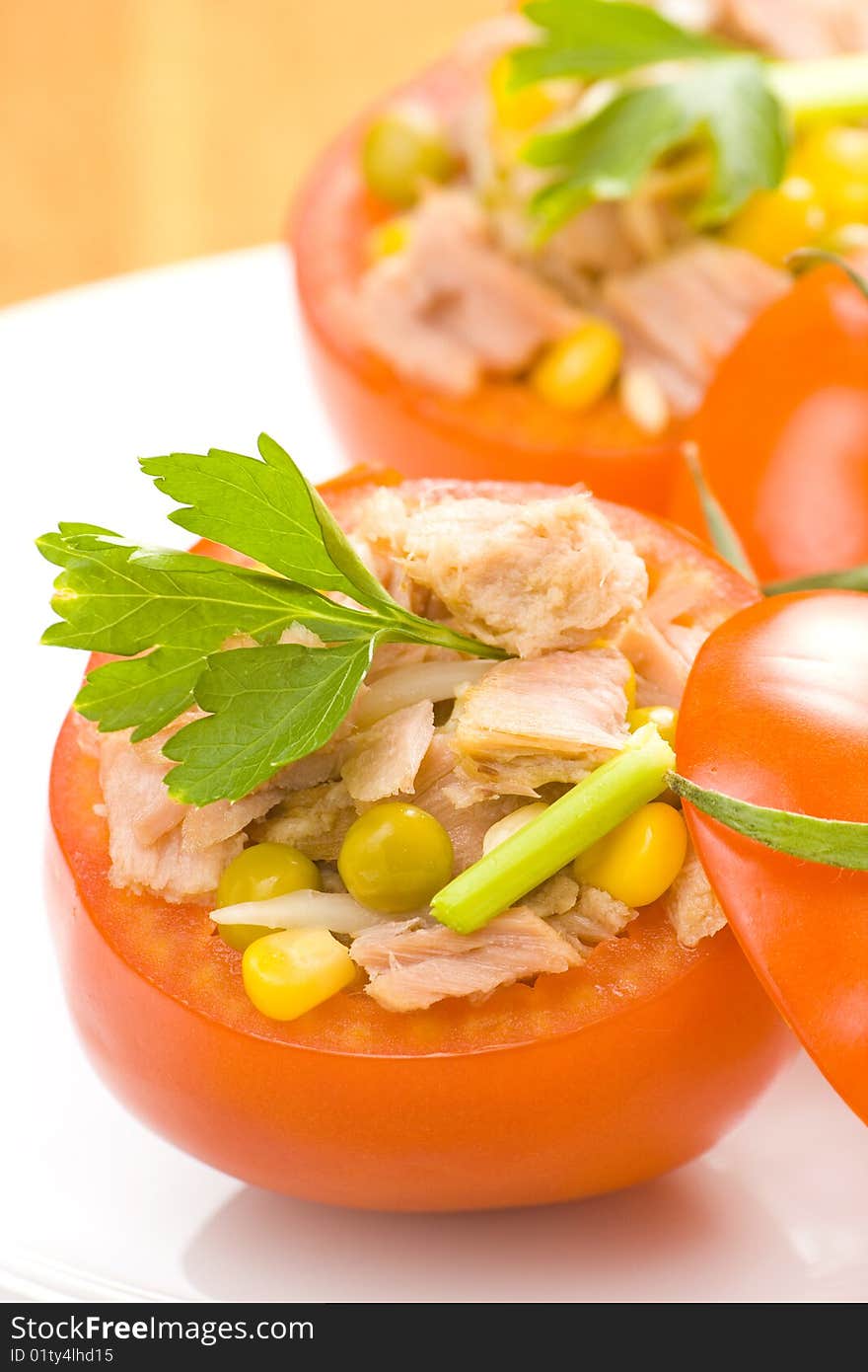 Tomatoes stuffed with tuna celery peas corn and soybeans. Tomatoes stuffed with tuna celery peas corn and soybeans