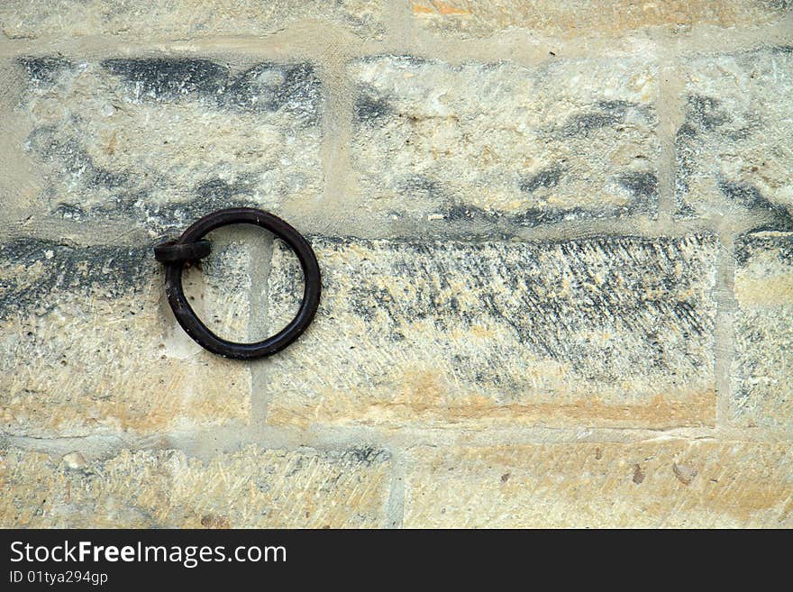 Iron ring set in a brick wall; with copy space