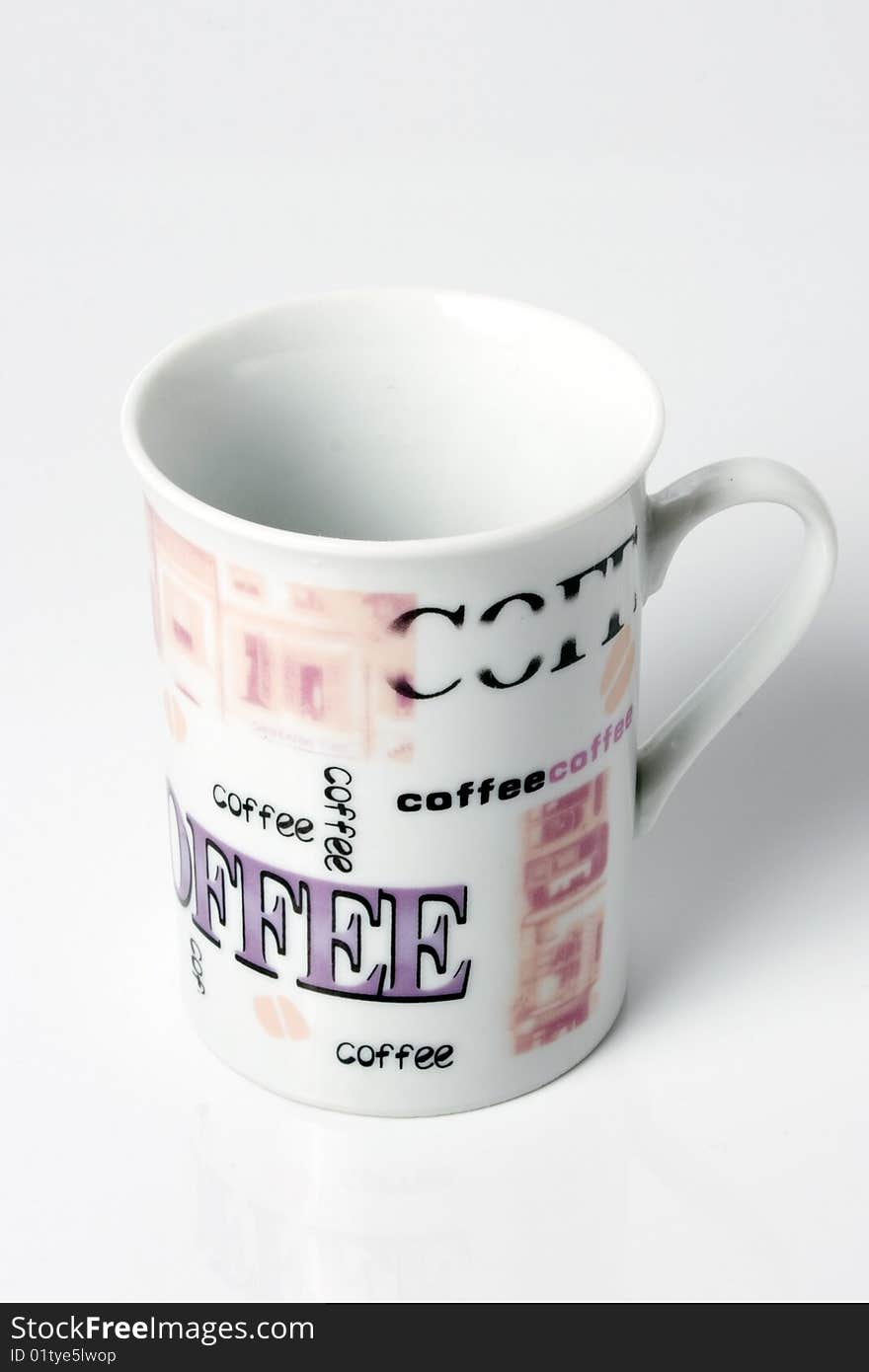 Empty white coffee cup with the word coffee printed all over in different letters and typos