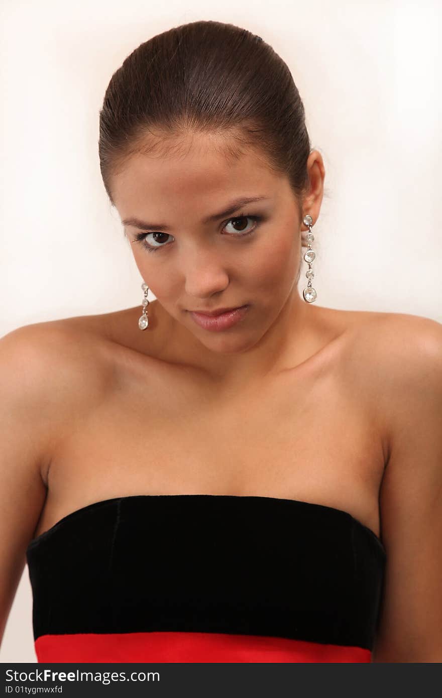 Young charming girl in an evening dress with bright make-up