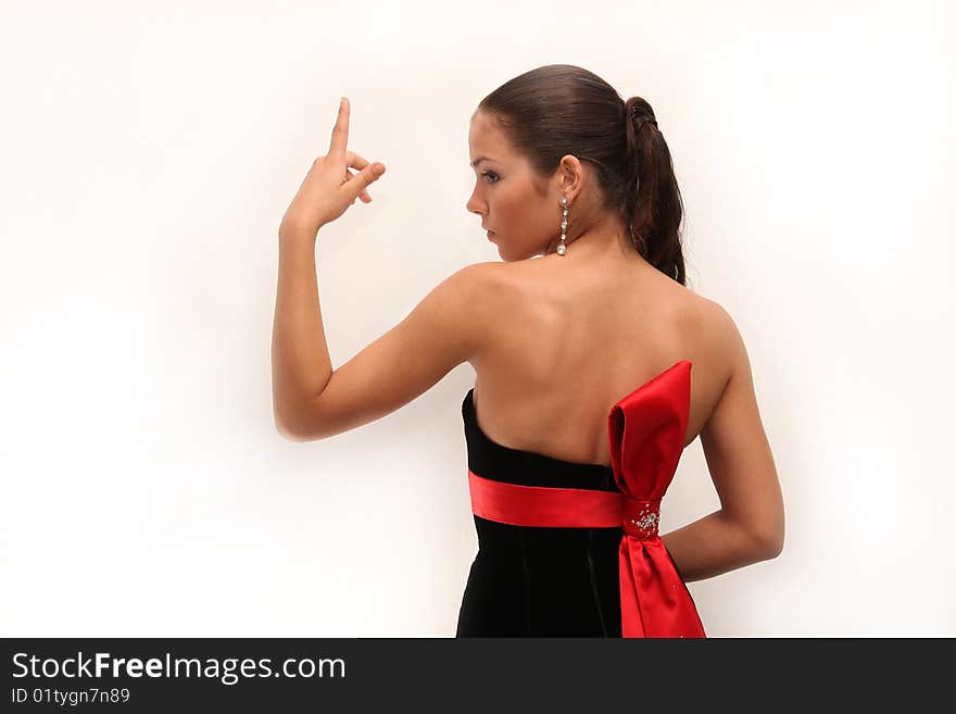 Young charming girl in an evening dress with bright make-up and the lifted hand