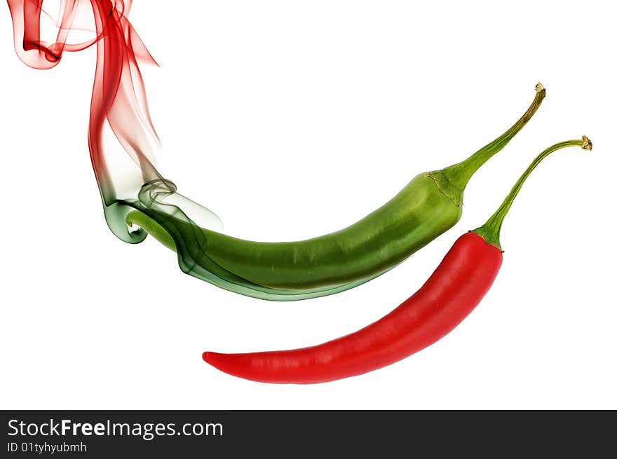 Red and green hot chili pepper with color smoke on white