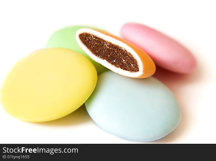 Round colorful candy tablets with one broken candy