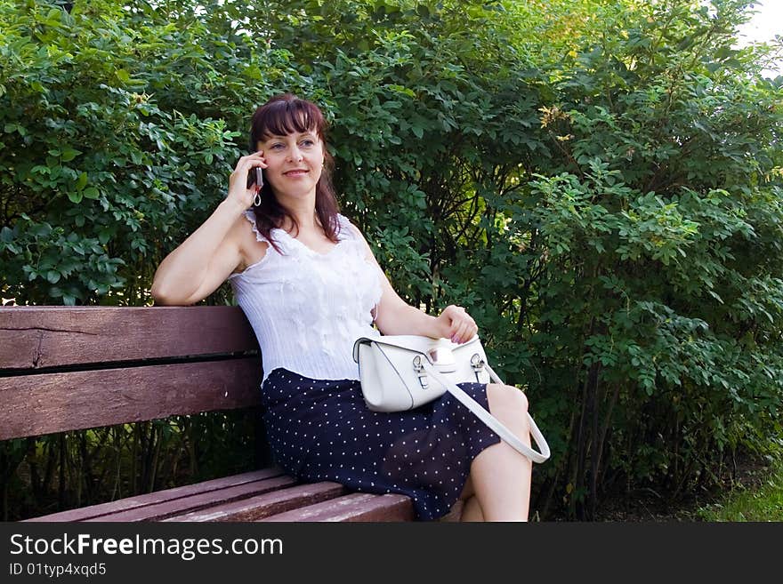 Middleaged woman talks on the mobile phone. Middleaged woman talks on the mobile phone