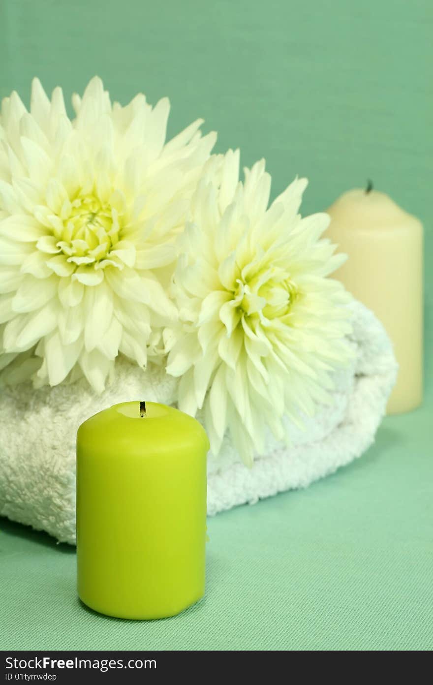 Towel, candles and flowers.