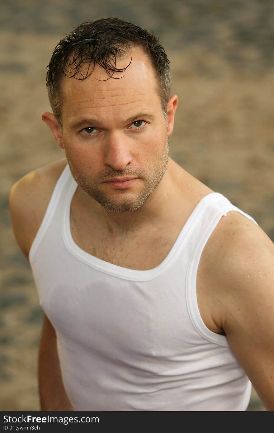 Portrait of tired man in undershirt outdoors